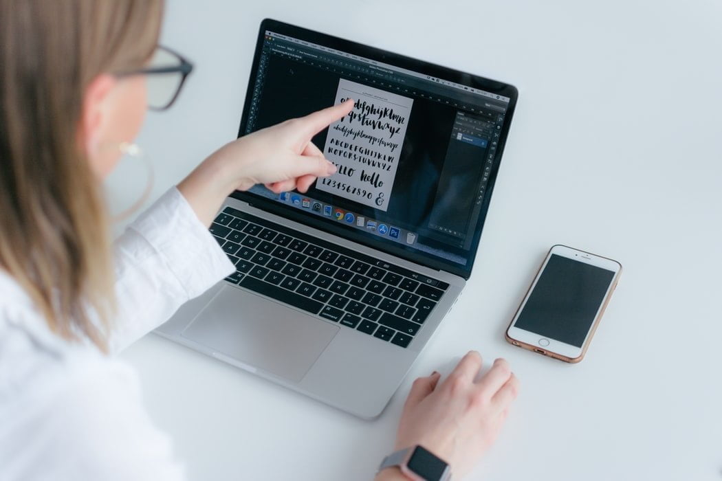 woman pointing on her laptop screen